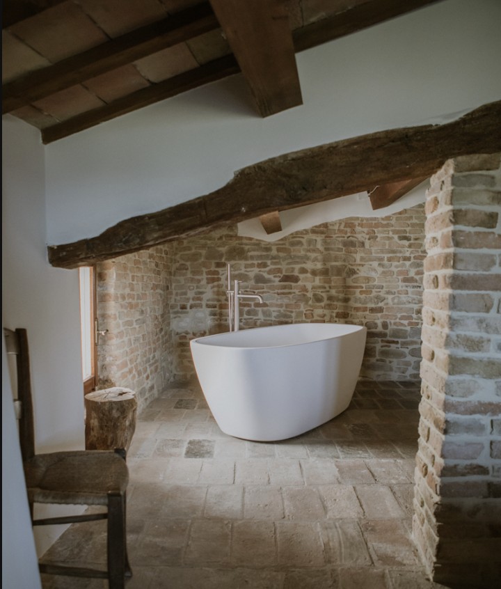 A freestanding bathtub and restored interiors at Borgo Loretello